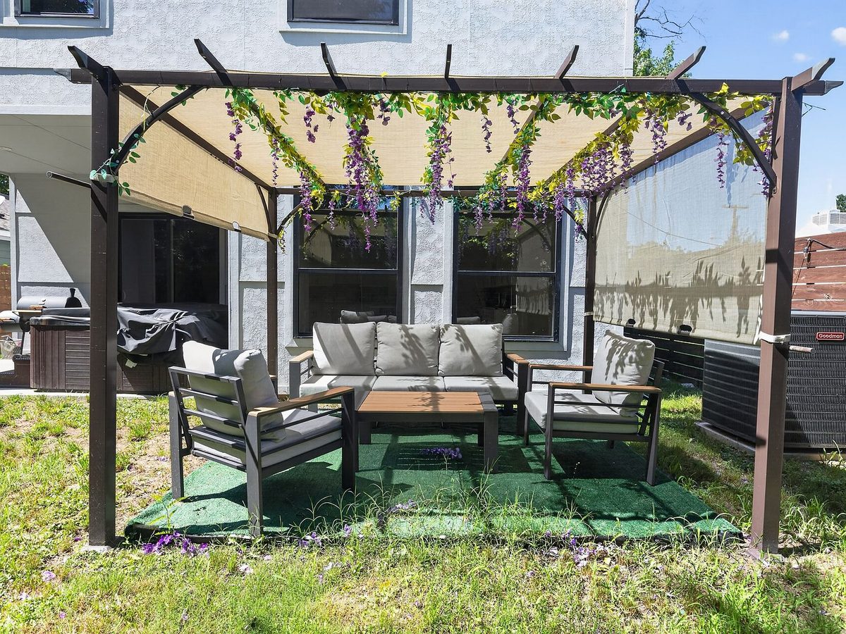 Patio with patchy weedy lawn before